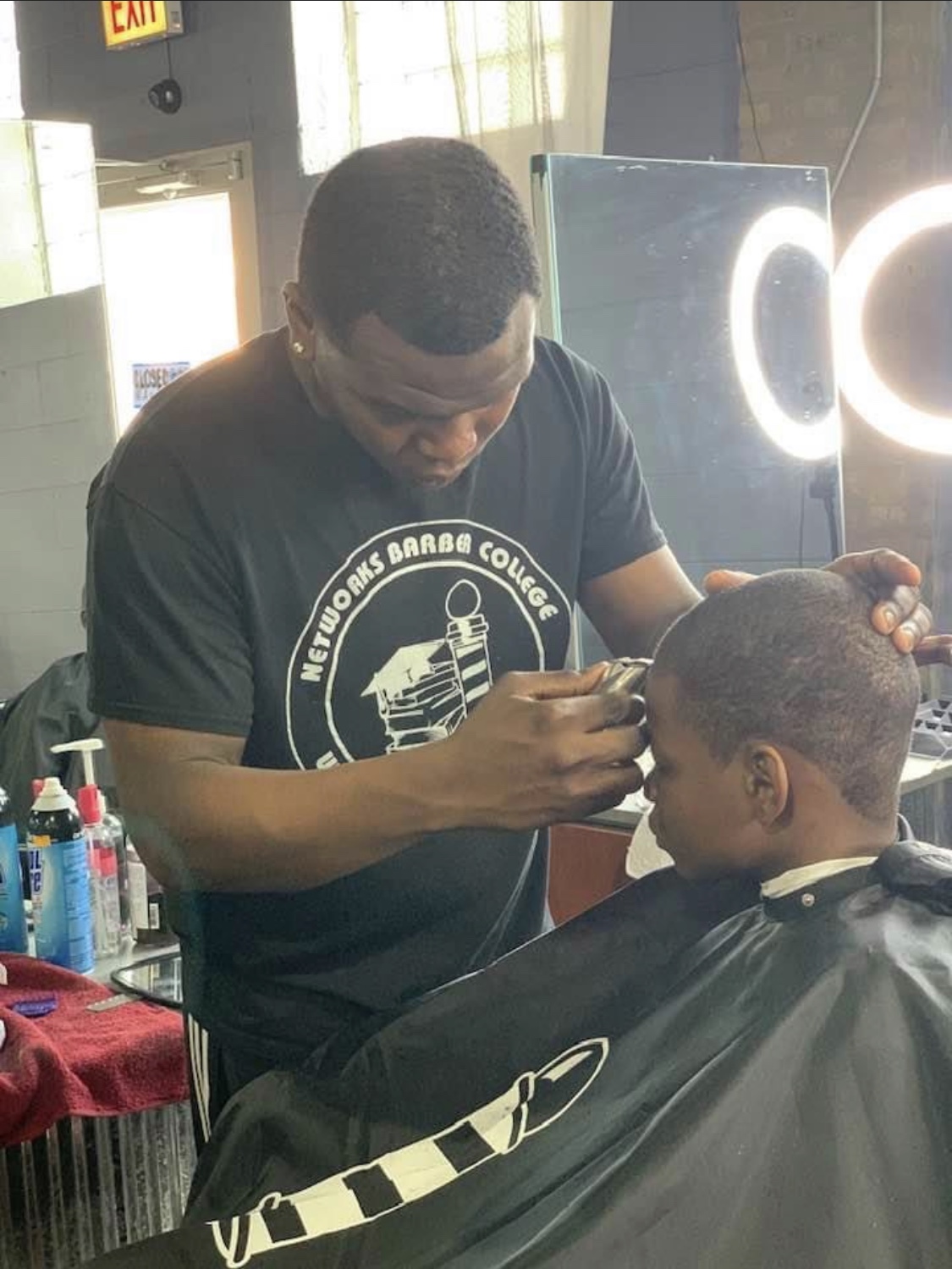 Students training at Networks Barber College